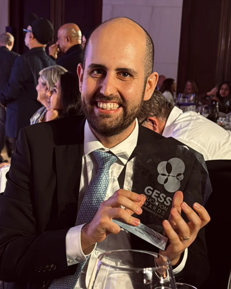 James Carne smiling and holding the GESS Rising Star trophy at the awards ceremony